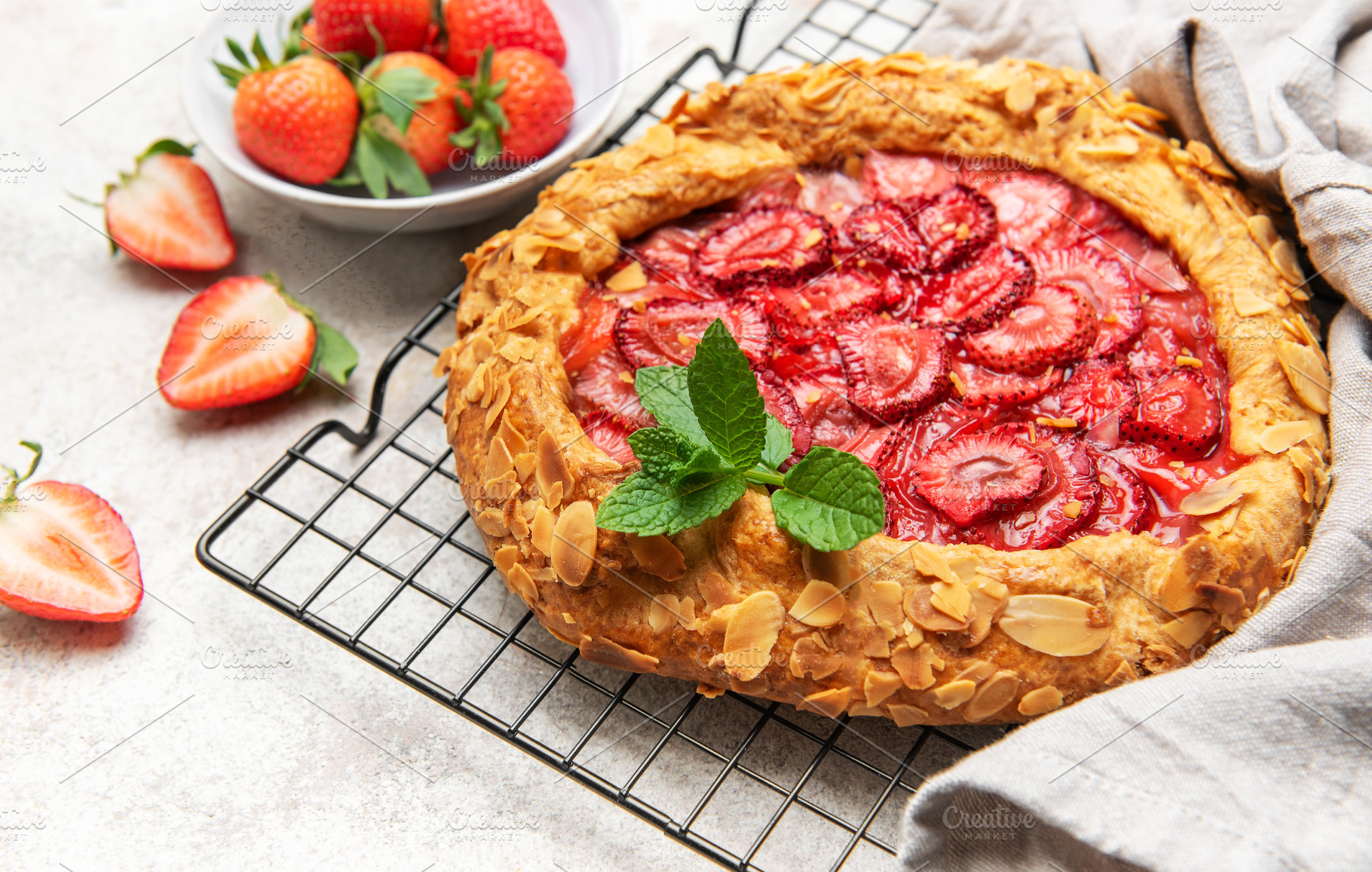 Delicious homemade strawberry galette cooling on wire rack, a Food & Drink Photo by Olena Rudo