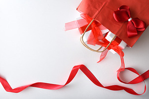 Gift concept with red shopping bag with gifts and ribbon, a Holiday Photo by Davizro's Market