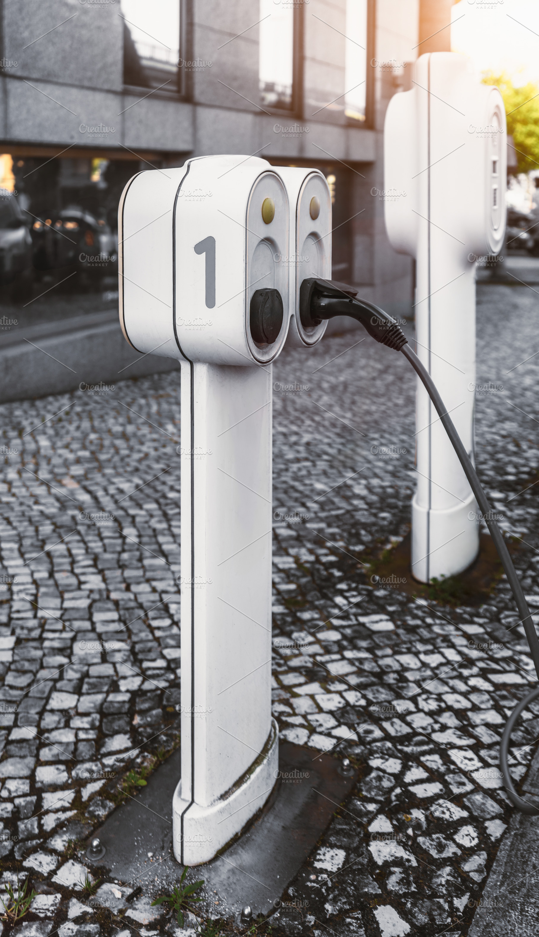 EV charger on stone pavement, a Transportation Photo by SkyNext