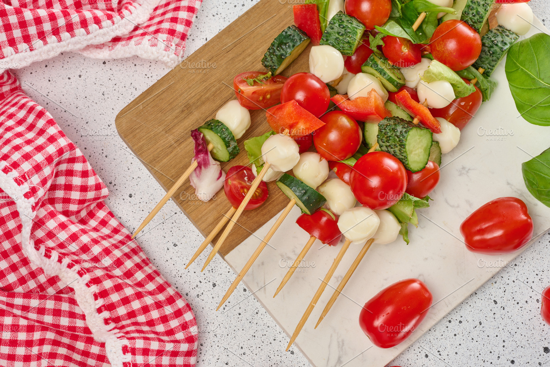 Light summer appetizer of vegetables and cheese on skewers on a, a Food & Drink Photo by ndanko