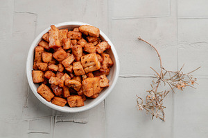high angle view of a bowl of marinated tofu cubes, a Photo by Nito