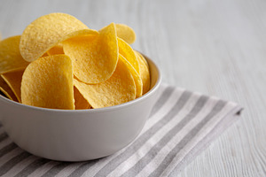 Potato Chips in a Bowl, side view. Copy space., a Food & Drink Photo by LiudmylaChuhunova