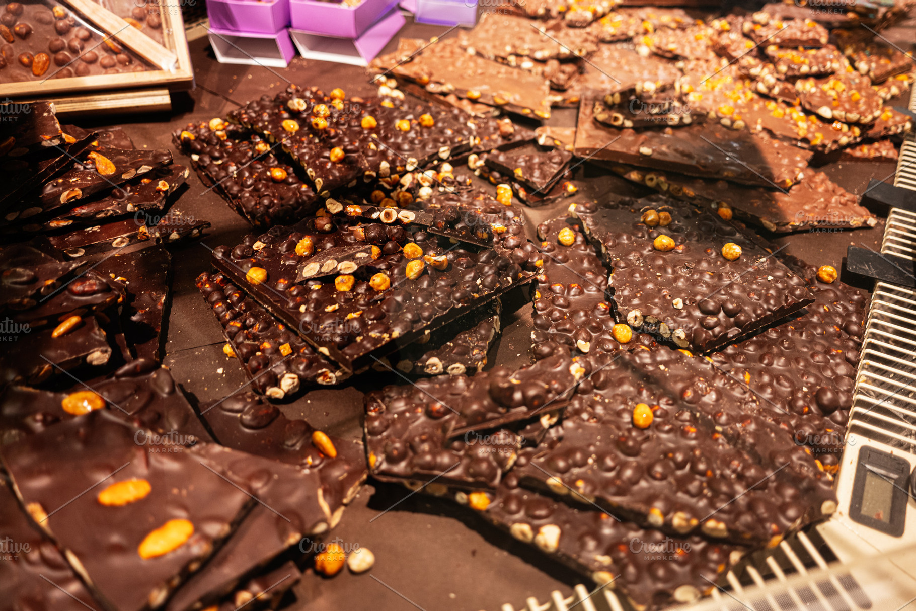 Delicious Assorted Chocolate Nut Bars Displayed in a Confectionery Store Settin, a Photo by AS photostudio