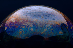 Close-up of a colorful soap bubble showing vibrant swirling patt, a Background Photo by Ales Munt