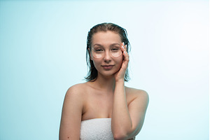Young woman applying undereye, a Person Photo by volodymyrshtun13795