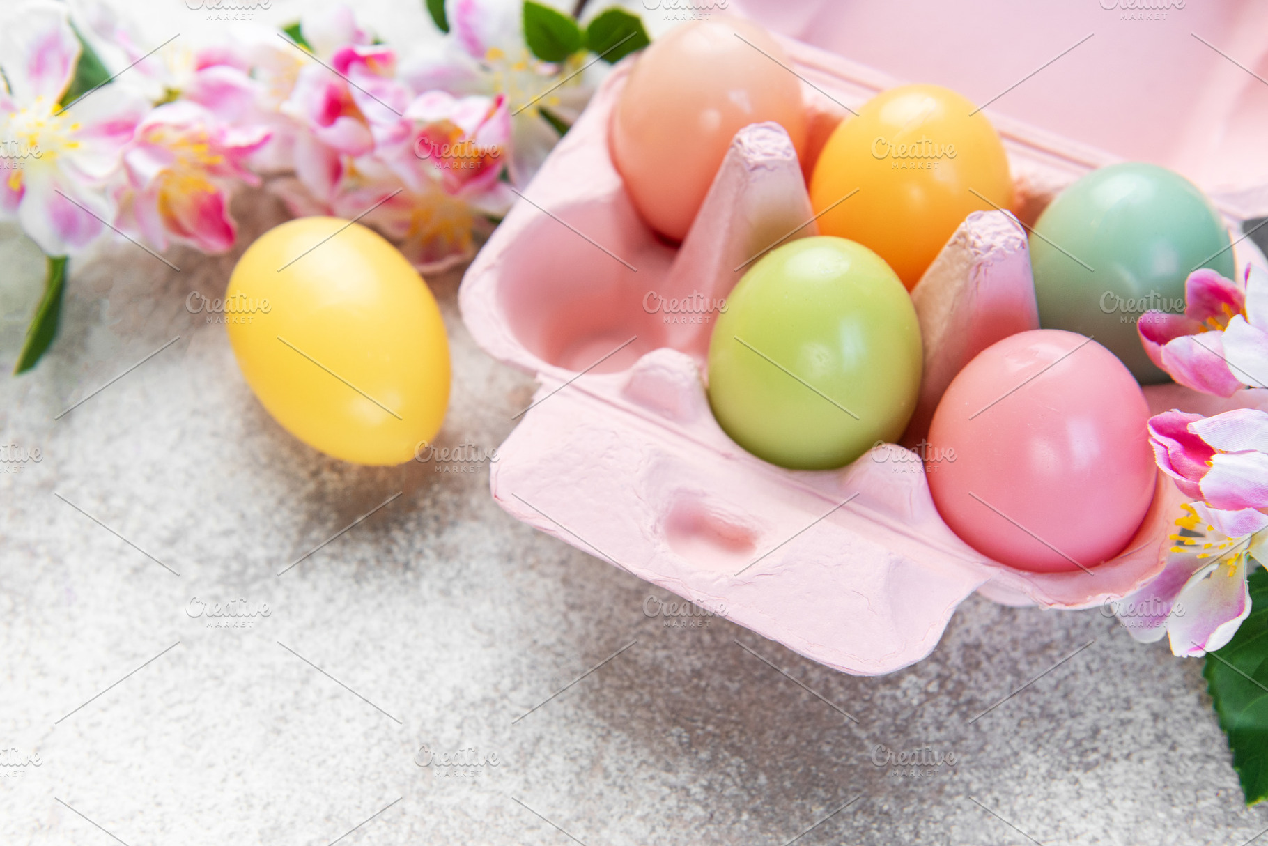 Colorful easter eggs in carton with spring flowers, a Holiday Photo by Olena Rudo