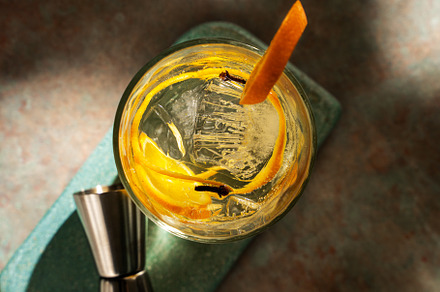 Glass of gin tonic with orange slice and ice. dark green backgro, a Food & Drink Photo by SZ IMAGE