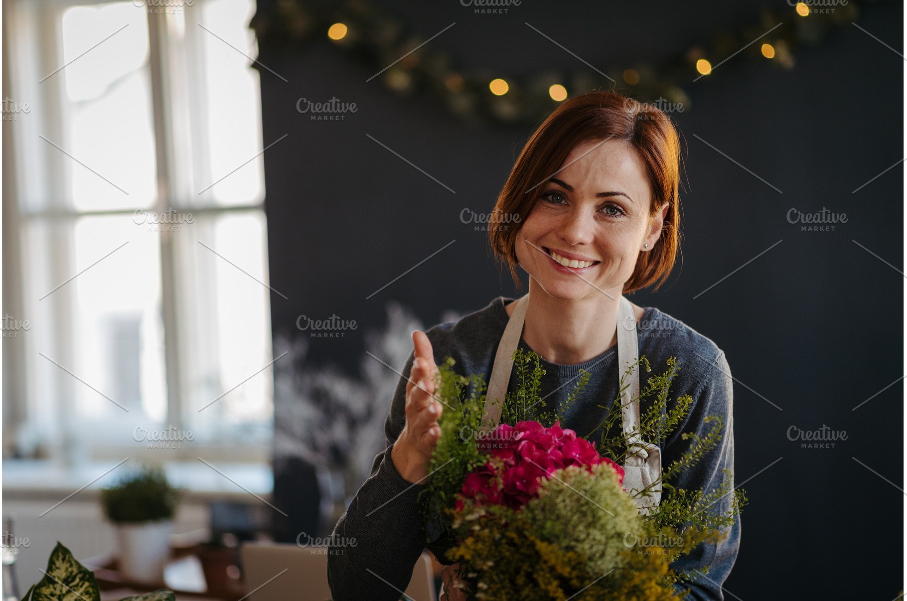 Smiling female florist working in, a Person Photo by HalfPoint