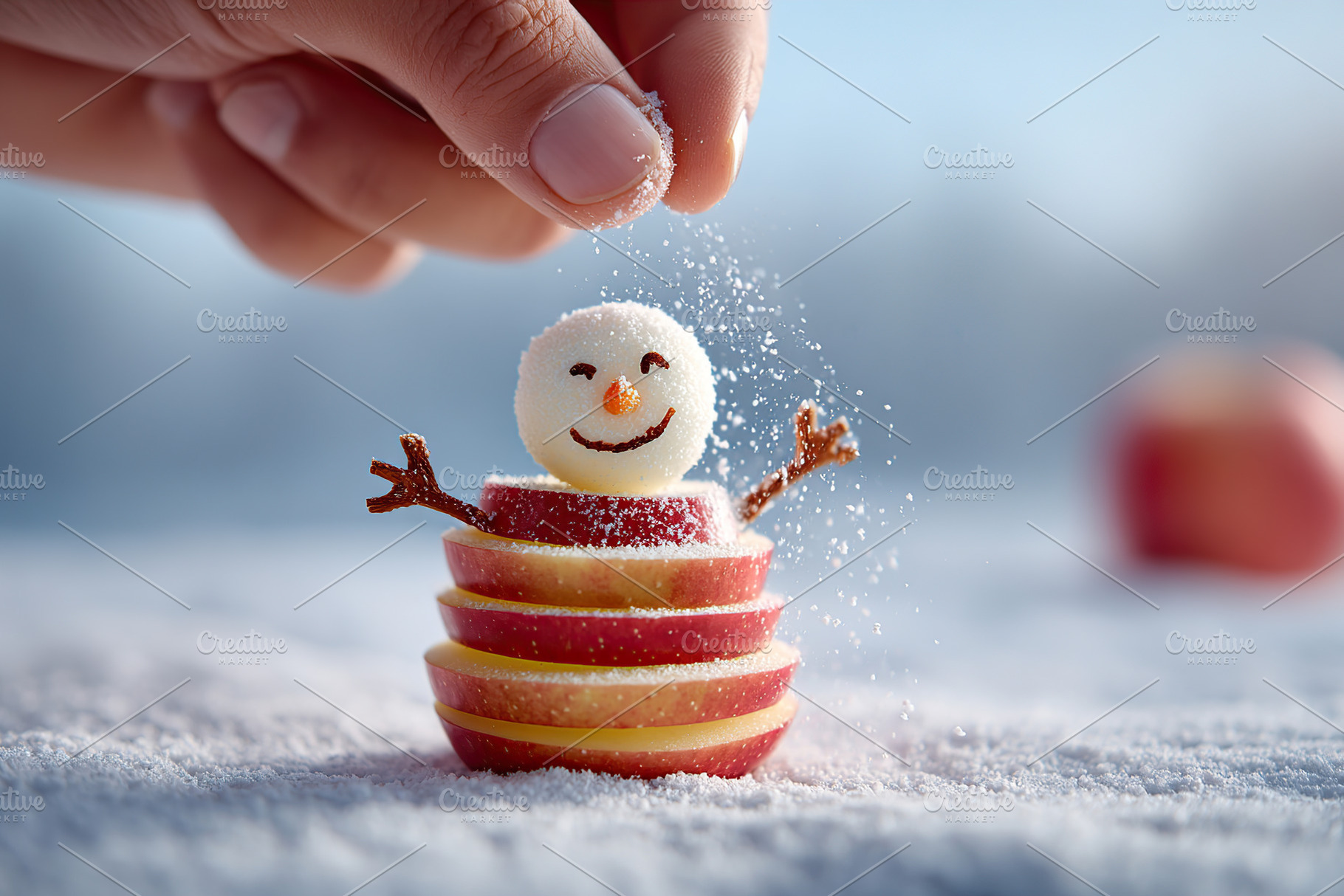 Building a tiny snowman with apple slices and sugar on a winter day outdoors, a Food & Drink Photo by AlyaAnd