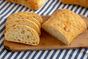 Homemade Cheese Ciabatta Bread on a Wooden Board, side view.