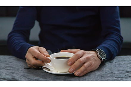 A man at the table with a cup of, a Person Photo by yanadjana