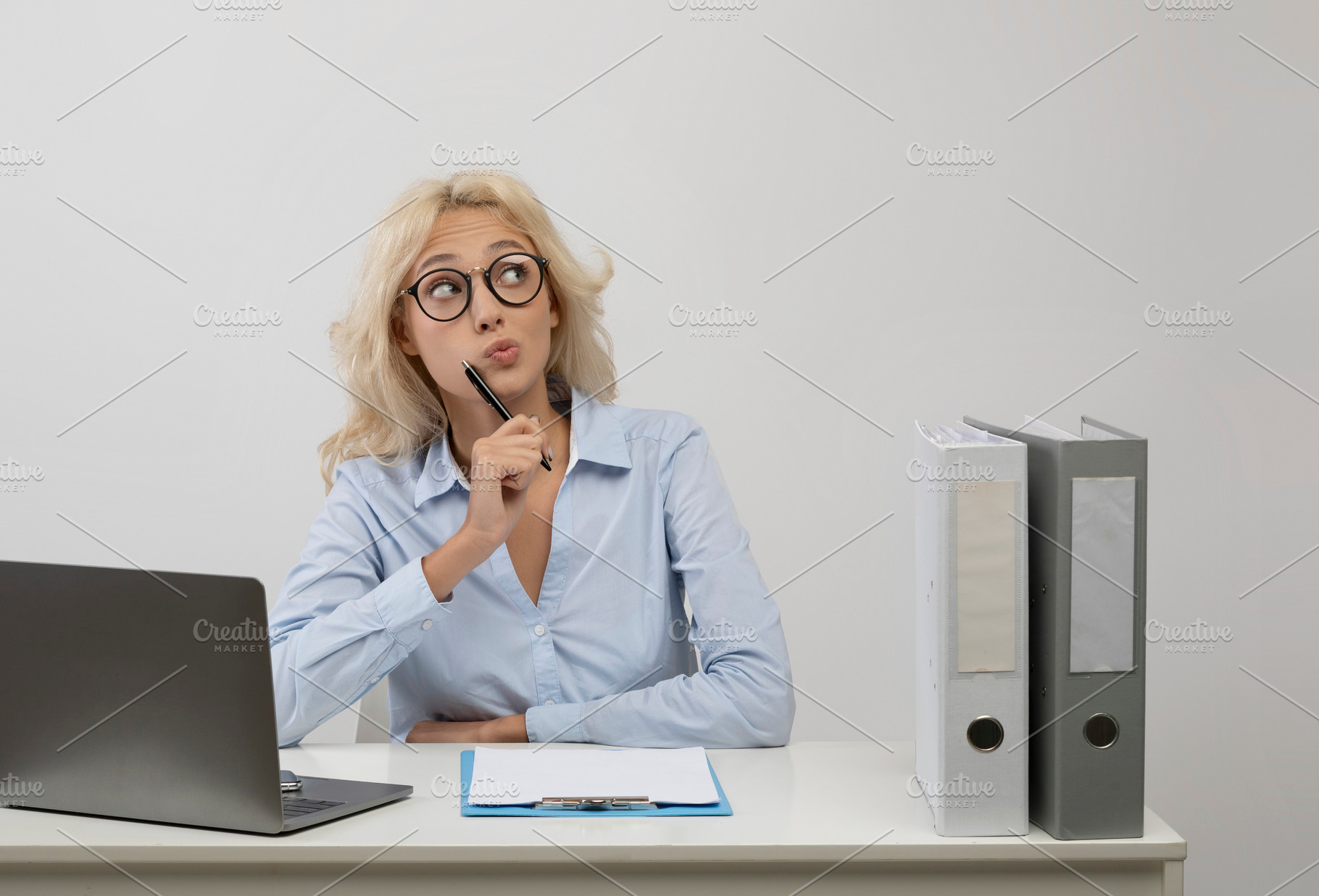 Pensive businesswoman thinking and looking aside at free space, sitting at work, a Photo by Prostock-Studio