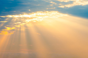 Sunset sky panorama with sun rays through clouds, a Nature Photo by Vapi