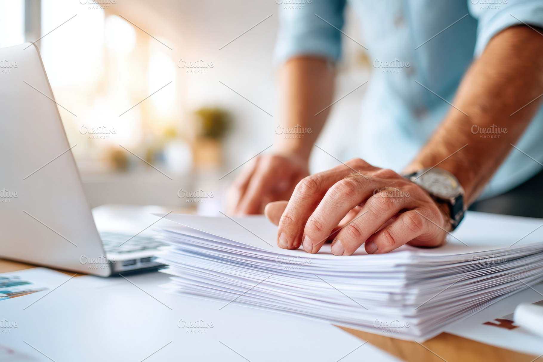 Organizing paperwork on a desk with laptop, a Business Photo by AlyaAnd