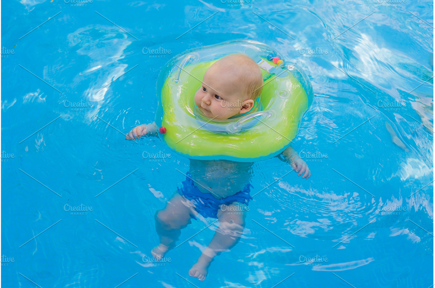 Baby swimming independently in a, a Person Photo by Elizaveta Galitskaya