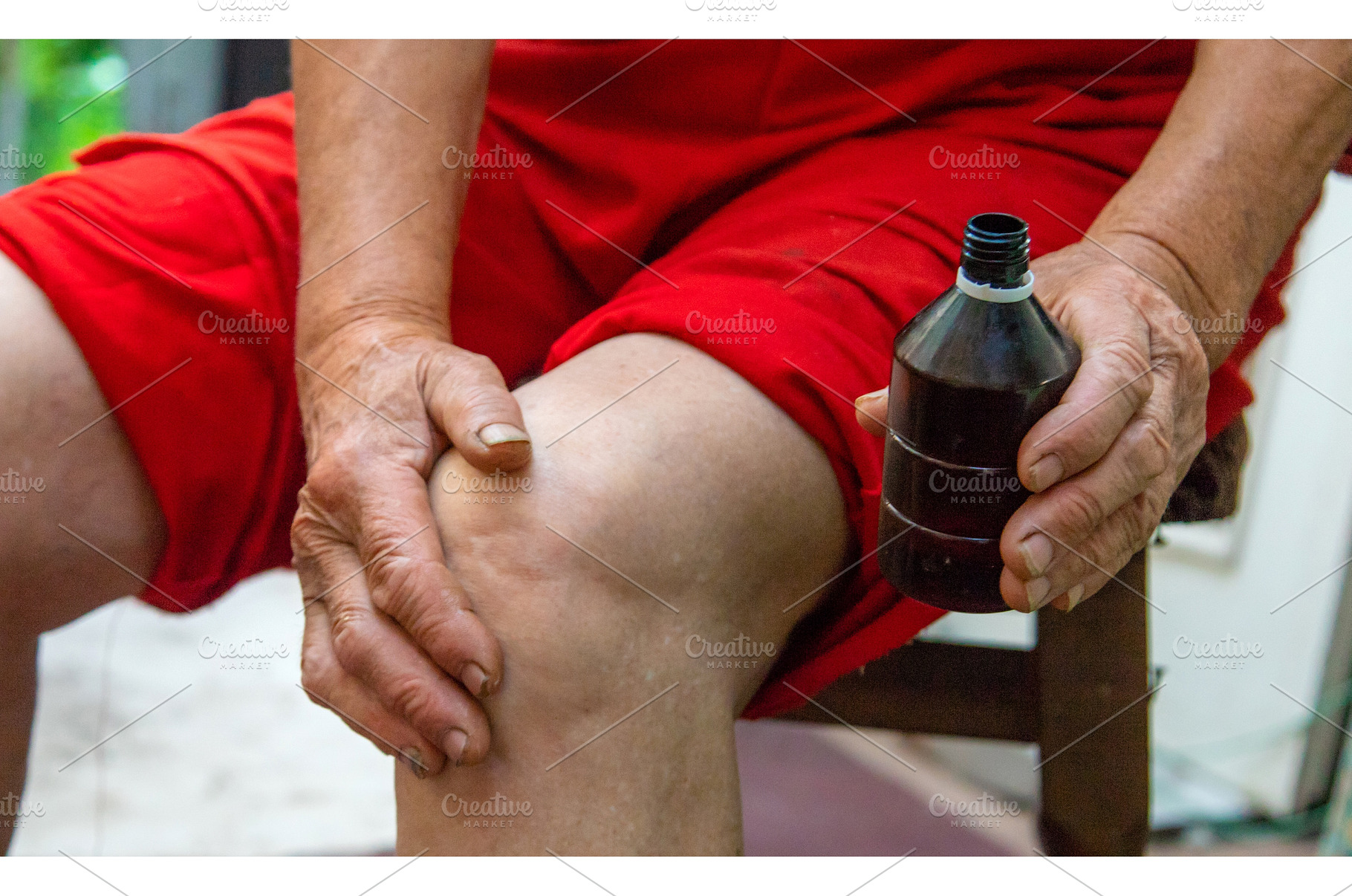 Grandmother treats her knees, smears, a Health & Medical Photo by yanadjana