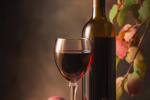 Red wine bottle and full glass with fresh peaches creating a rustic still life, a Food & Drink Photo by Studio ANNA