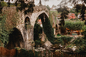 Ivy-covered Roman bridge at dusk in, an Architecture Photo by Perpis