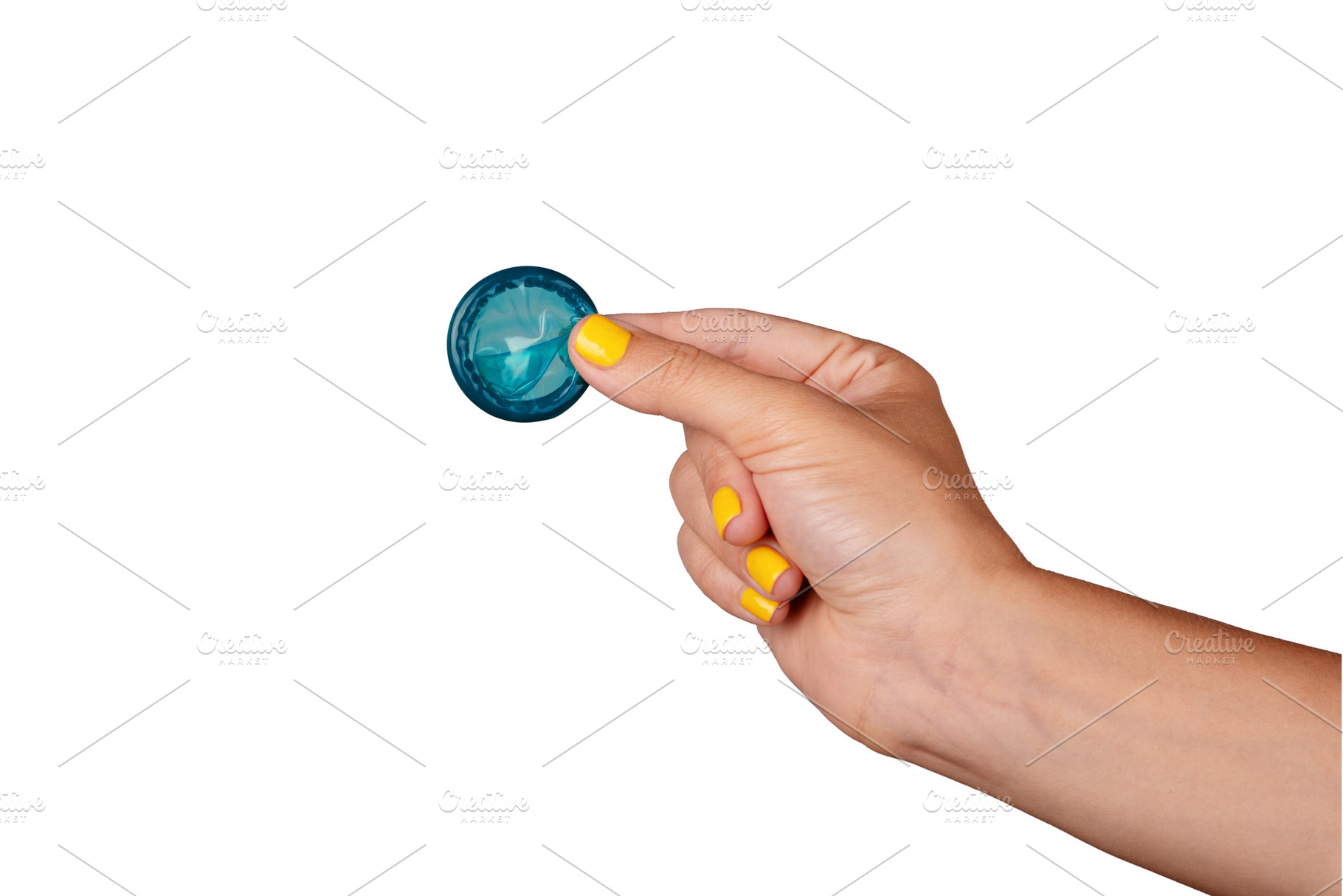 Close-up of a hand with yellow nail polish holding an unrolled b, a Health & Medical Photo by Ales Munt