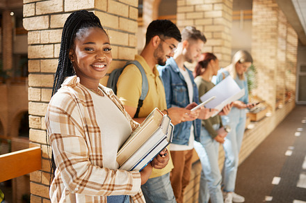 University, hallway and portrait of black woman and students standing in row together with books before class. Friends, education and future learning, girl in study group on campus in lobby for exam., a Photo by Peopleimages.com