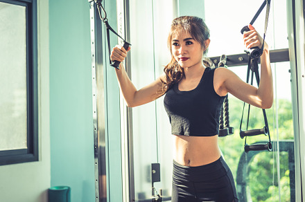 Asian young woman doing elastic rope exercises at cross fitness, a Sports & Recreation Photo by Ministocker