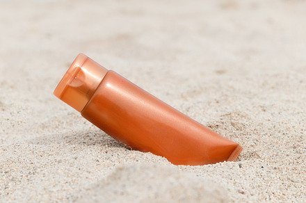 Sunscreen sunblock spf cream on the containing background, beach, and beauty