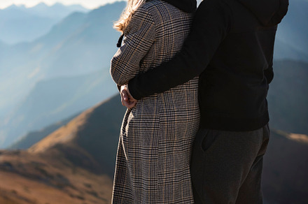 Happy couple having a break during a hiking trip in the mountain, a Sports & Recreation Photo by Olena Rudo