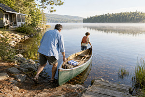 People by lake with canoe and cabin,, a Photo by Dvoevnore photos
