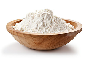Flour in wooden bowl on white background, a Food & Drink Photo by AlyaAnd