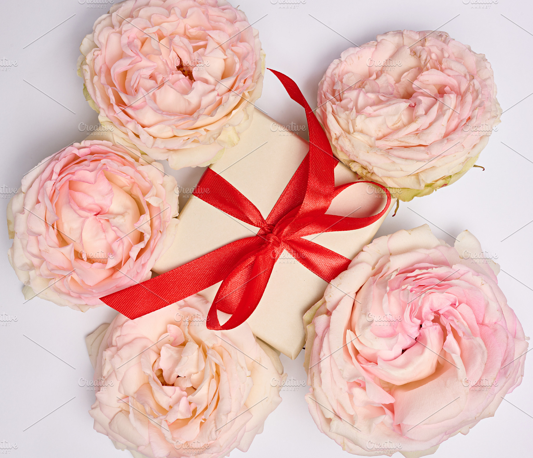 Festive arrangement with a gift box tied with a red ribbon, surr, a Holiday Photo by ndanko
