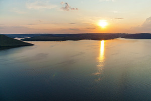 Sunset reflection over calm river landscape, a Nature Photo by Photostock