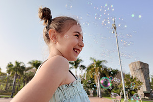 Little Girl Playing with Soap Bubbles in Golden Sunlight, a Person Photo by etorres69