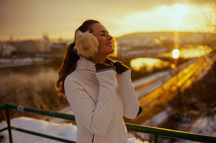 relaxed active woman in white jacket with ear warmer, a Sports & Recreation Photo by Alliance Images