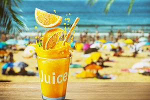 Glass of orange juice with drink splash. Blurred photo of crowde, a Food & Drink Photo by Volff