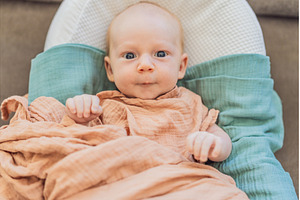 Newborn baby comfortably resting in, a Health & Medical Photo by Elizaveta Galitskaya
