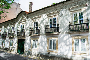 Historic building facade with balconies in Caldas da Rainha, Portugal on a brig, a Photo by AS photostudio
