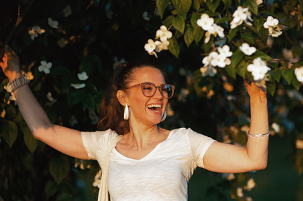 smiling elegant woman in white shirt with eyeglasses, a Person Photo by Alliance Images