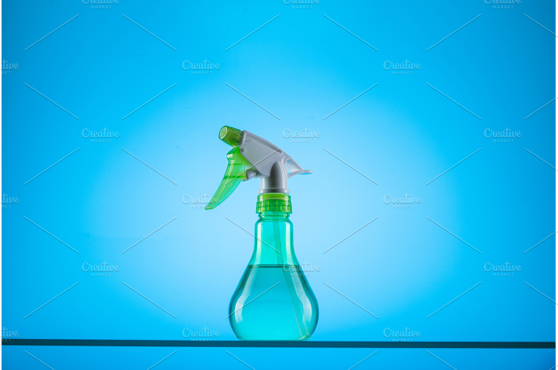 Spray bottle on a blue background, a Nature Photo by Stockphoto by vzwer