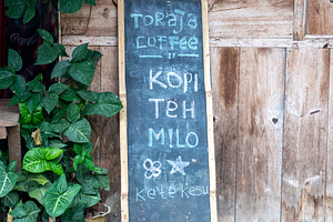 Coffee shop menu sign in Toraja village, Sulawesi, Indonesia, an Architecture Photo by GoodGoods
