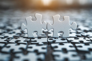 Two puzzle pieces connect on a dark, a Photo by Tanuart