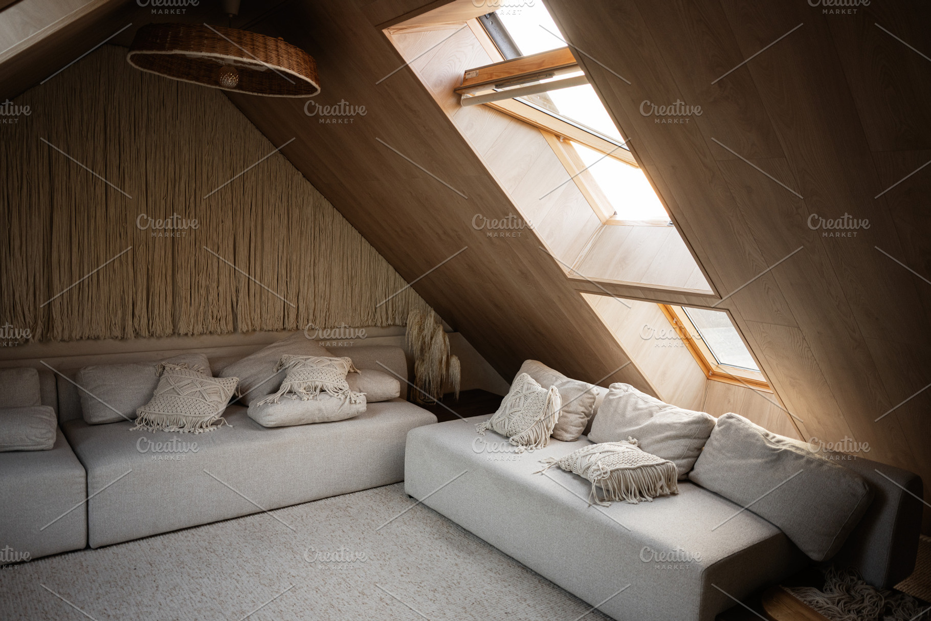 Cozy attic space with soft seating and natural lighting from skylights, a Photo by AS photostudio