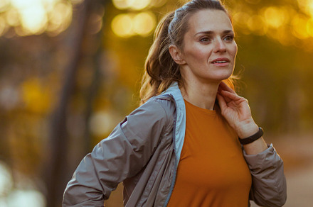 stylish woman in fitness clothes in park looking into distance, a Sports & Recreation Photo by Alliance Images