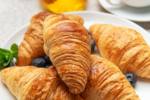 Delicious french croissants with coffee, honey, and fresh bluebe, a Food & Drink Photo by Olena Rudo