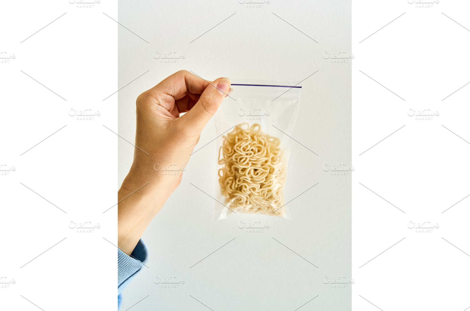 Hand holding ziplock bag with cooked, a Food & Drink Photo by Gladkov photography