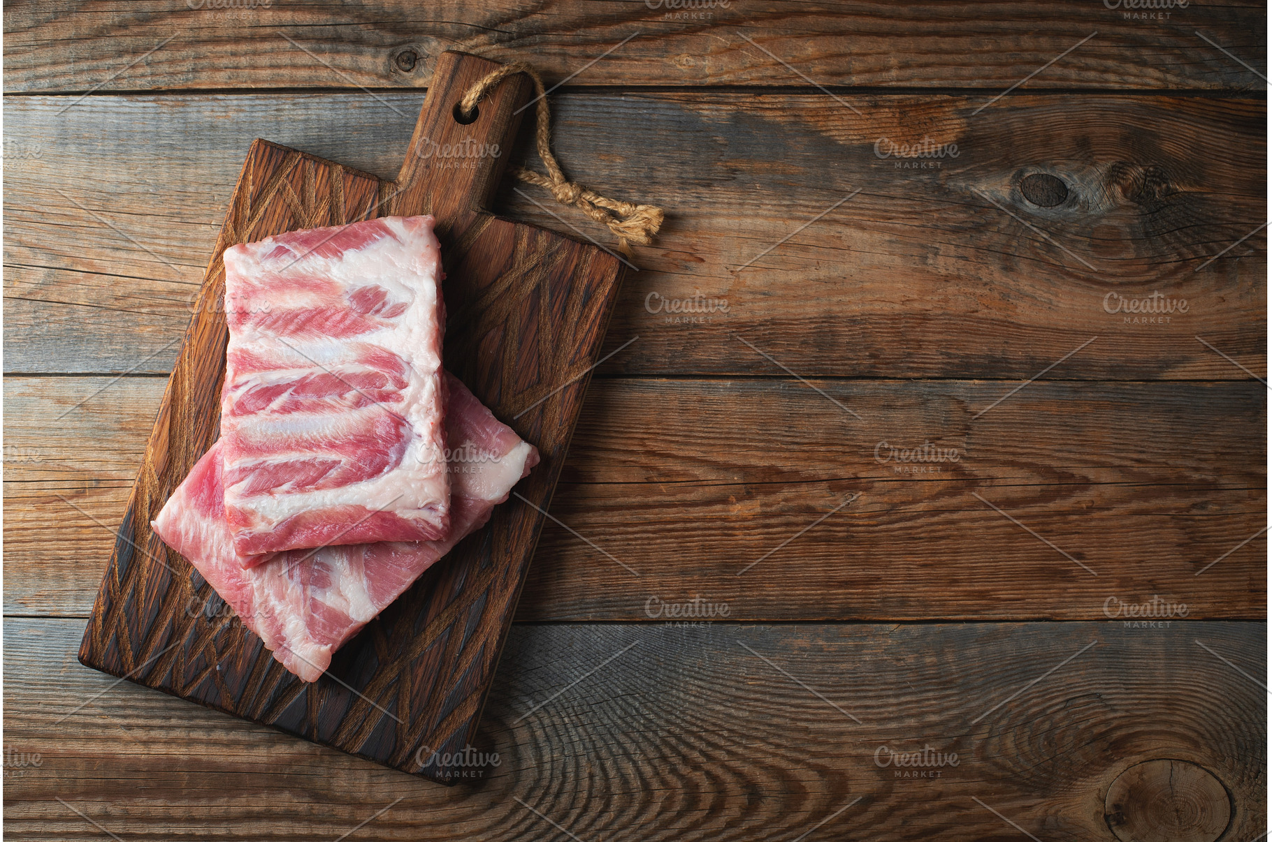 Raw pork ribs with spices, salt and, a Food & Drink Photo by Budarinphoto