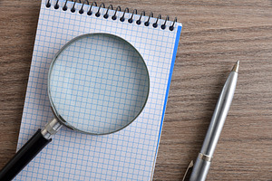 Magnifying Glass on Blank Notebook Page, a Business Photo by Davizro's Market