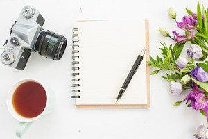Flat lay desk with tea and flowers containing flatlays, desk, and top