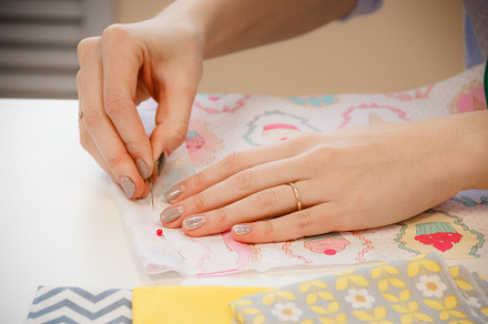 Young seamstress measuring the length with pins, a Person Photo by Maxim Beykov