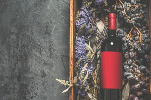 Red wine bottle with empty red label, a Food & Drink Photo by VICUSCHKA