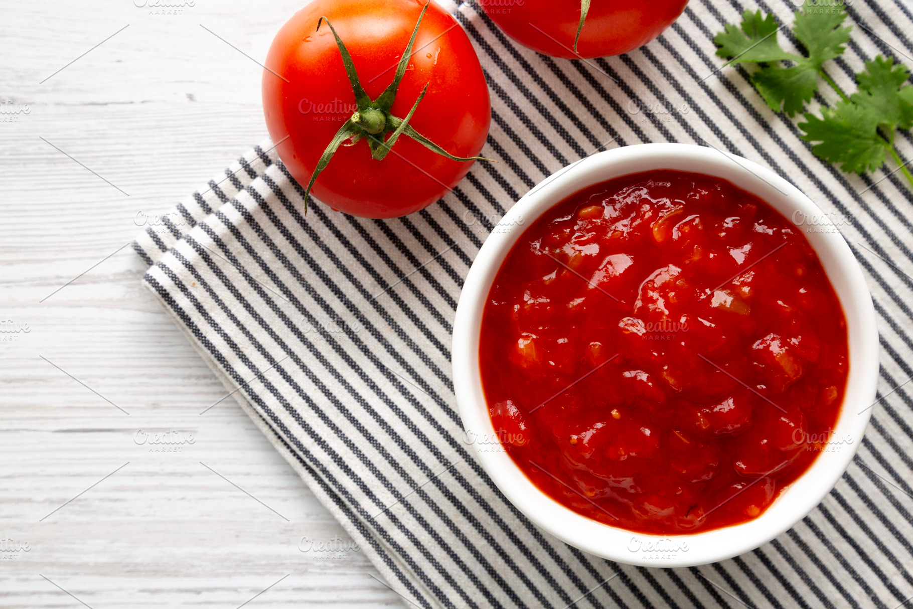 Organic Tomato and Cilantro Salsa in a Bowl, top view. Copy spac, a Food & Drink Photo by LiudmylaChuhunova